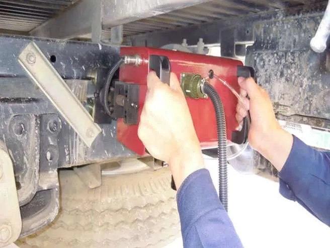 portable marking d7x24 9g 1 Technician installing diagnostic device on truck chassis